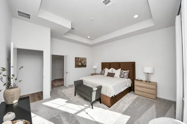 a bedroom with a bed and a table