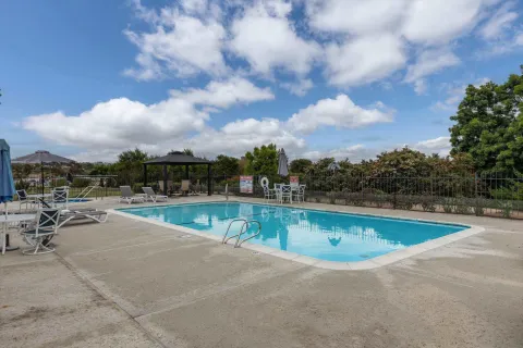 a view of a swimming pool with a lounge chair
