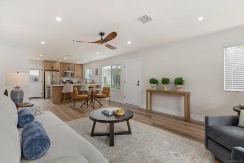 a living room with furniture a rug and a chandelier