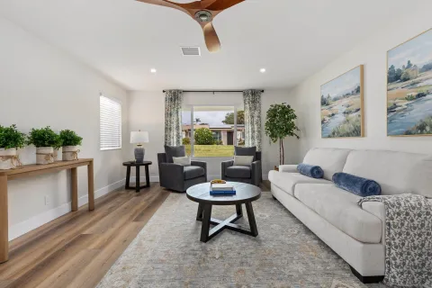 a living room with furniture a window and a chair