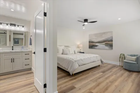 a spacious bedroom with a bed and a dresser