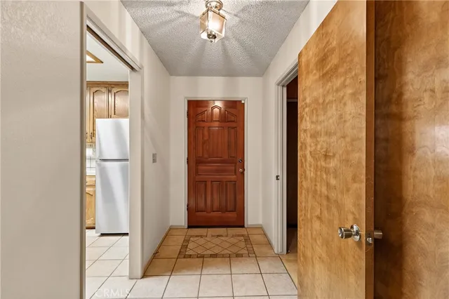 a view of a hallway with wooden shelves