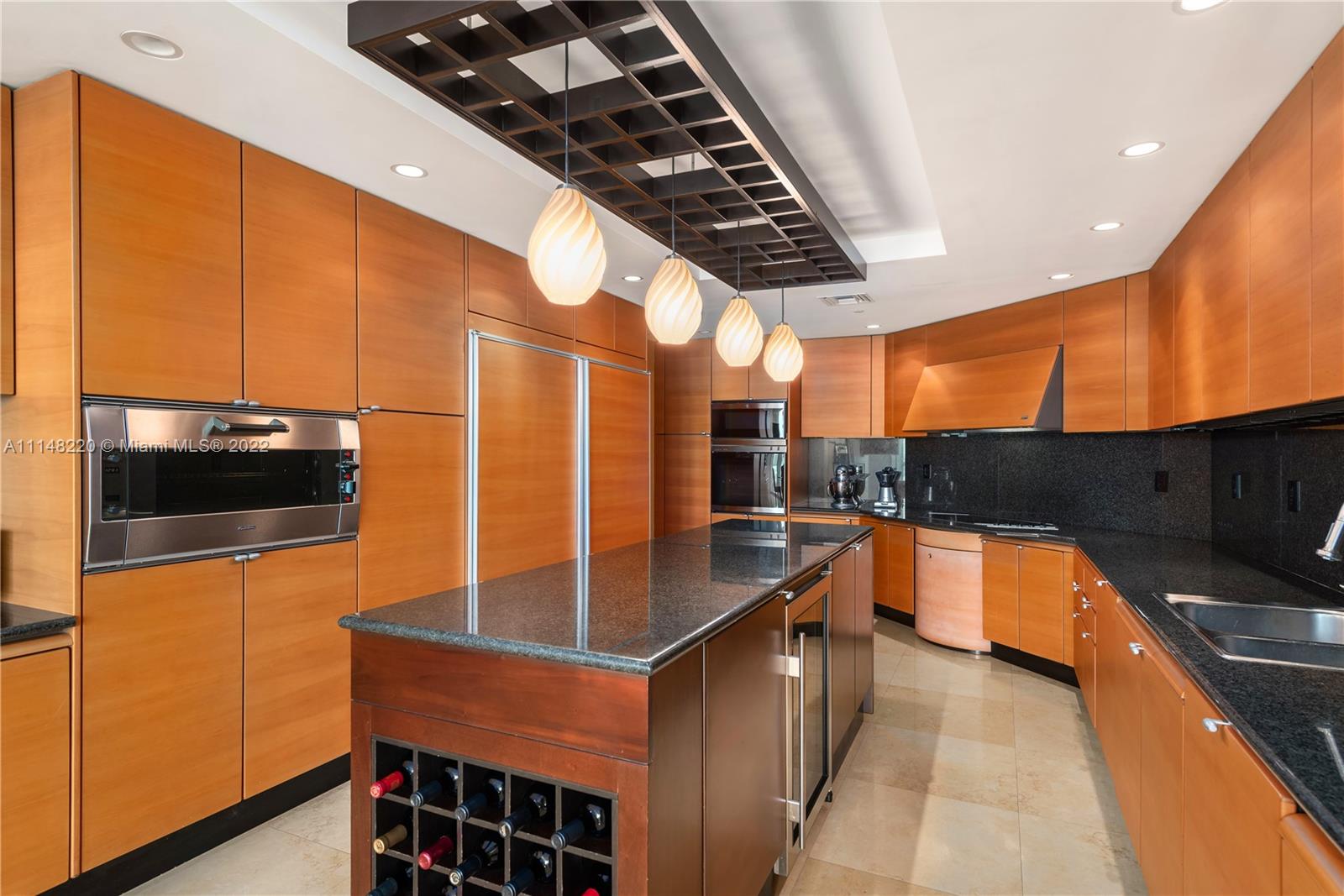 1643 Brickell Avenue, Unit 3702 Miami, FL 33129 - Photo 13 of 15 a kitchen with stainless steel appliances a stove a sink and a microwave