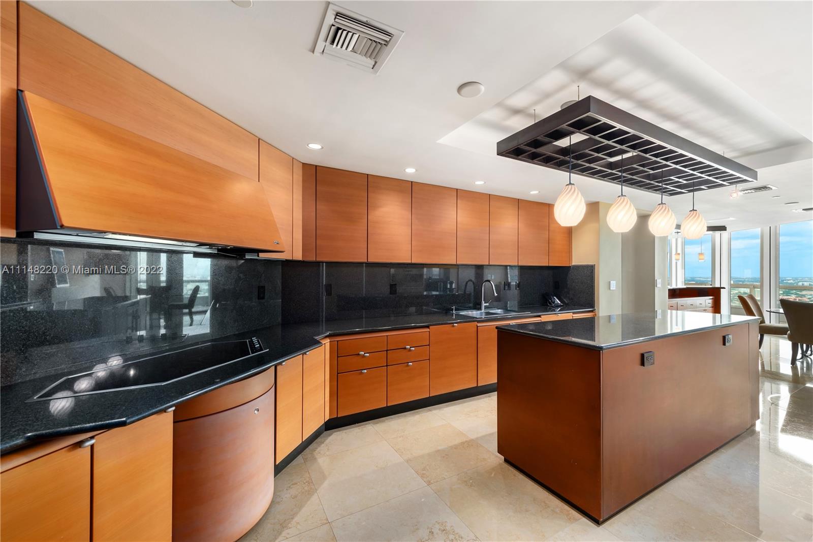 1643 Brickell Avenue, Unit 3702 Miami, FL 33129 - Photo 6 of 15 a kitchen with stainless steel appliances kitchen island granite countertop a sink and stove top oven