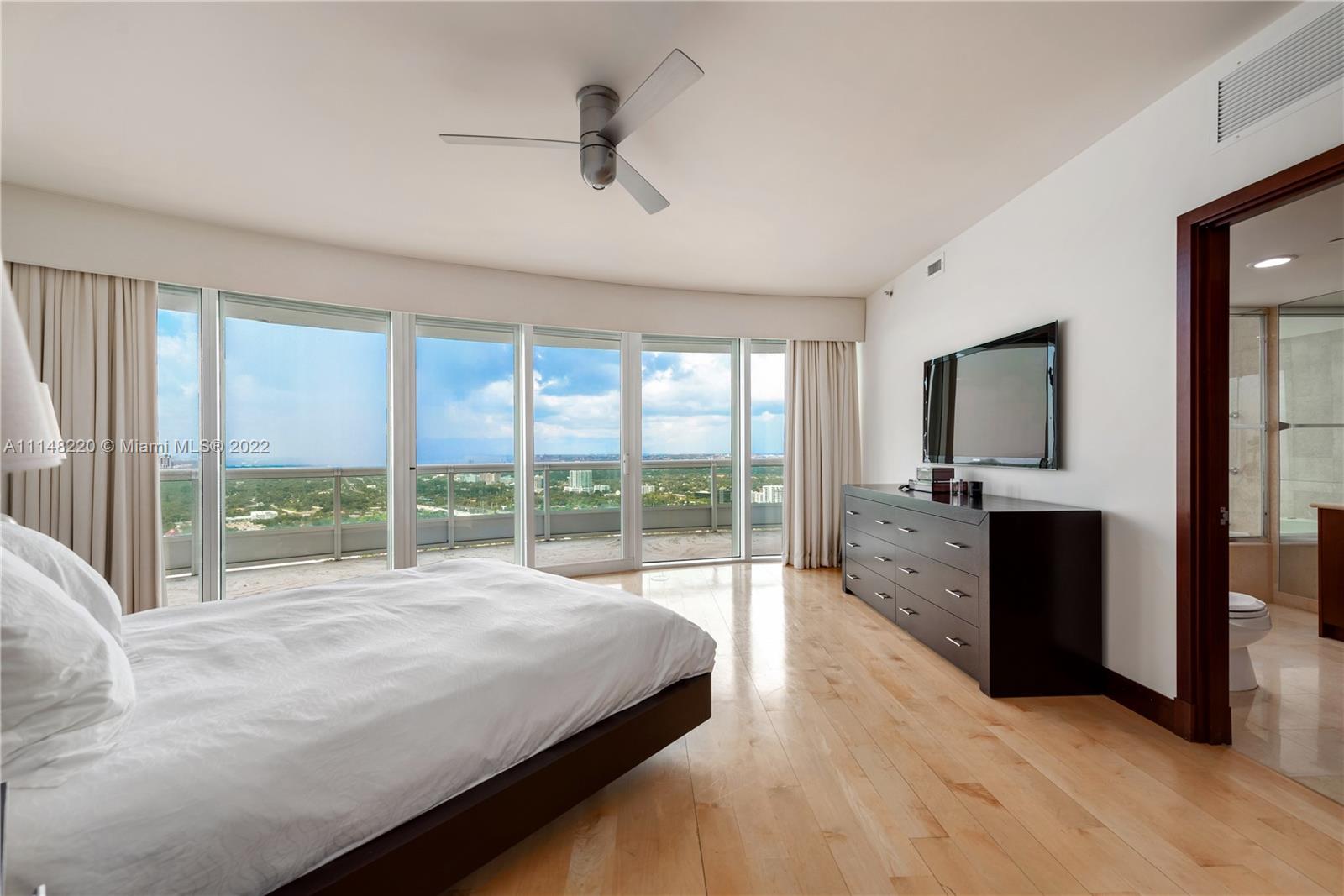 1643 Brickell Avenue, Unit 3702 Miami, FL 33129 - Photo 8 of 15 a spacious bedroom with a large bed and a large window