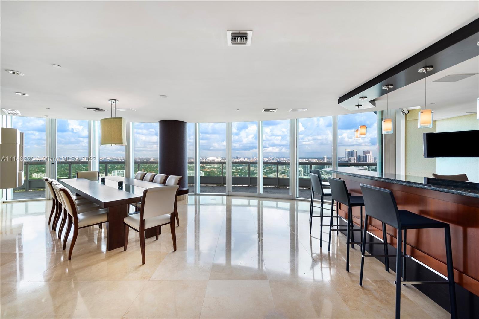 1643 Brickell Avenue, Unit 3702 Miami, FL 33129 - Photo 9 of 15 a dining room with furniture a chandelier and wooden floor