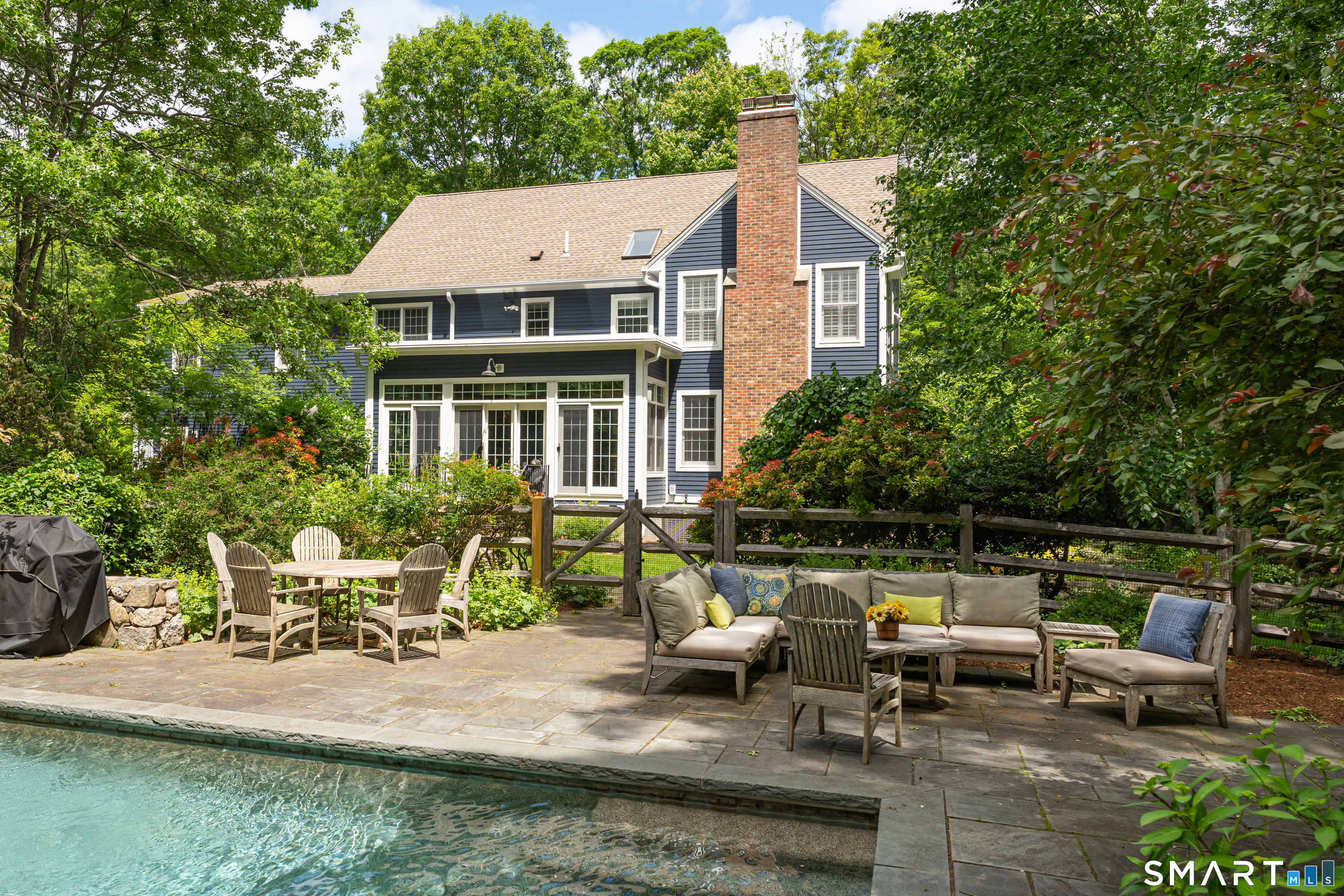 46 Laurel Cliffs Road Guilford, CT 06437 - Photo 27 of 40 The pool surround with a view of the rear of the house.
