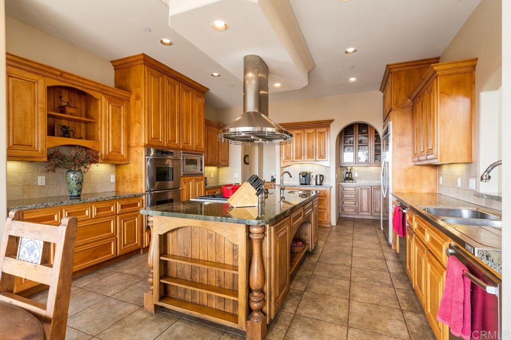 10363 Hidden Meadows Road Escondido, CA 92026 - Photo 19 of 65 a kitchen with stainless steel appliances granite countertop a sink and a stove