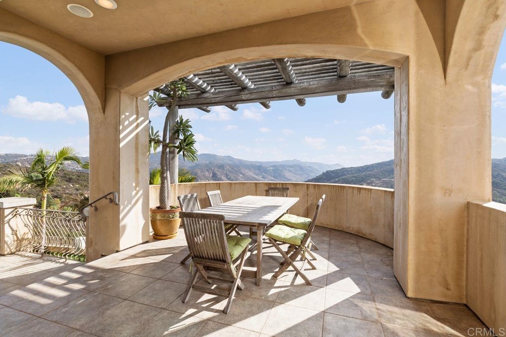 10363 Hidden Meadows Road Escondido, CA 92026 - Photo 22 of 65 a patio with table and chairs and potted plants