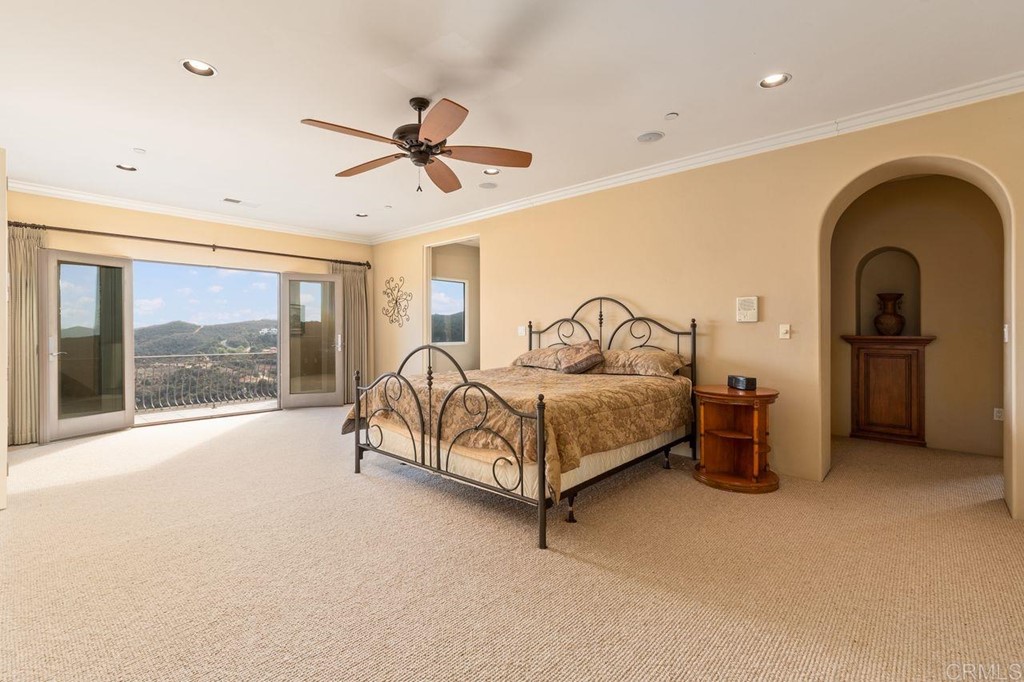 10363 Hidden Meadows Road Escondido, CA 92026 - Photo 27 of 65 a bedroom with a bed and a large window
