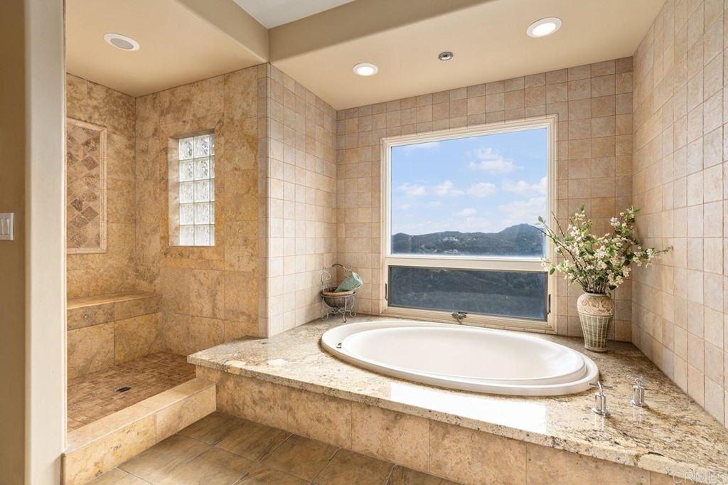 10363 Hidden Meadows Road Escondido, CA 92026 - Photo 30 of 65 a bathroom with a granite countertop sink a toilet a mirror and shower