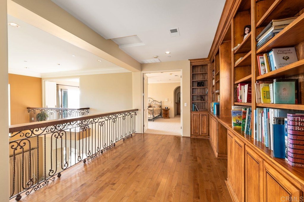 10363 Hidden Meadows Road Escondido, CA 92026 - Photo 34 of 65 a view of a hallway with wooden floor and staircase
