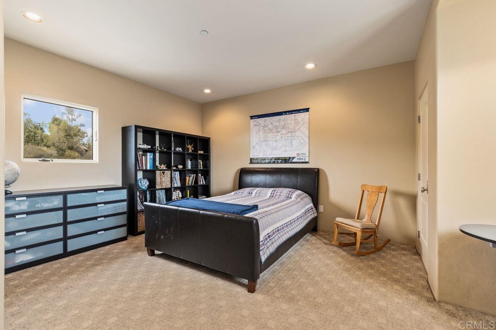 10363 Hidden Meadows Road Escondido, CA 92026 - Photo 35 of 65 a spacious bedroom with a bed and a bookshelf