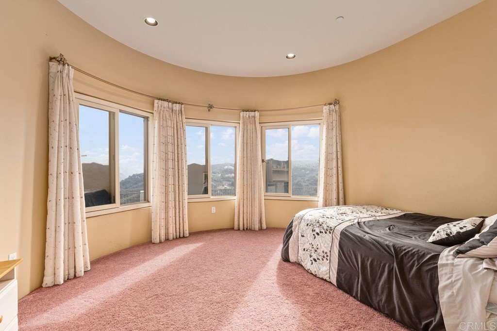 10363 Hidden Meadows Road Escondido, CA 92026 - Photo 40 of 65 a spacious bedroom with a large bed and a large window