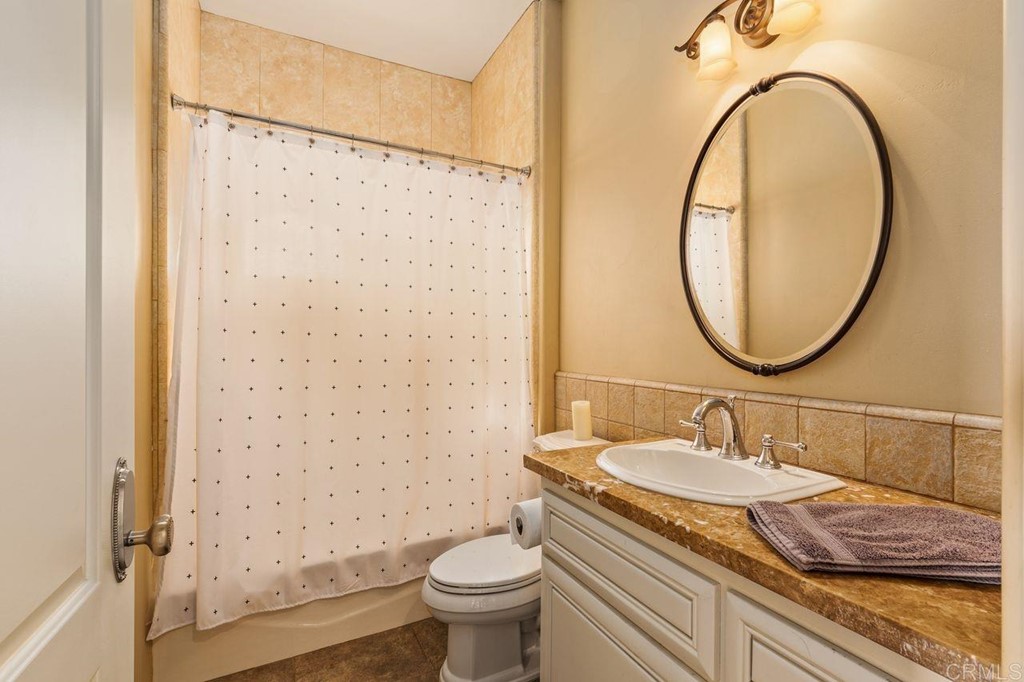 10363 Hidden Meadows Road Escondido, CA 92026 - Photo 41 of 65 a bathroom with a granite countertop sink toilet and shower