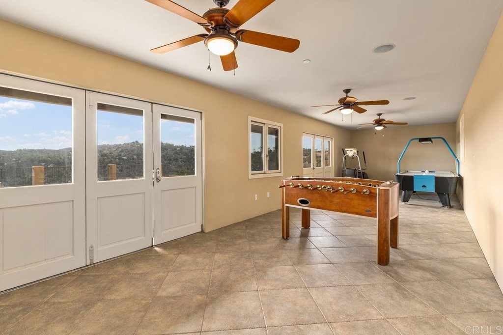 10363 Hidden Meadows Road Escondido, CA 92026 - Photo 45 of 65 a living room with couches a dining table and chairs with a ceiling fan