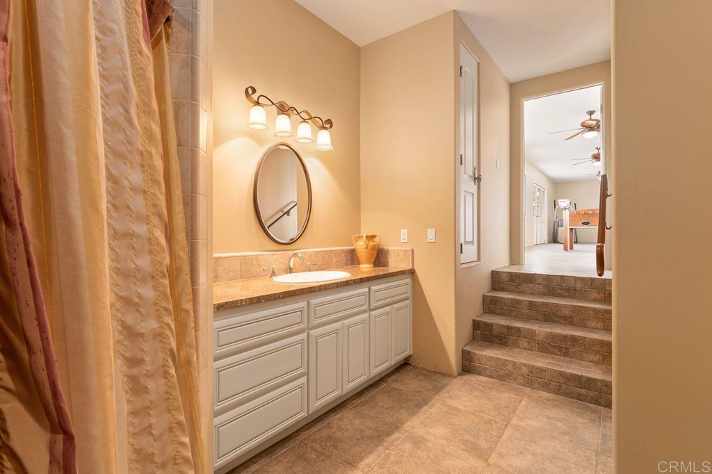 10363 Hidden Meadows Road Escondido, CA 92026 - Photo 46 of 65 a bathroom with a double vanity sink and a mirror