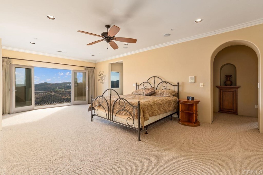 10363 Hidden Meadows Road Escondido, CA 92026 - Photo 57 of 65 a bedroom with a bed and with a large window