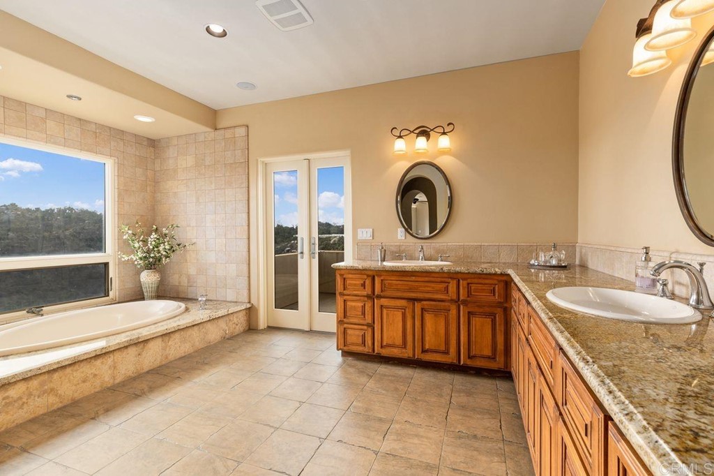 10363 Hidden Meadows Road Escondido, CA 92026 - Photo 59 of 65 a bedroom with a large bed and a sink