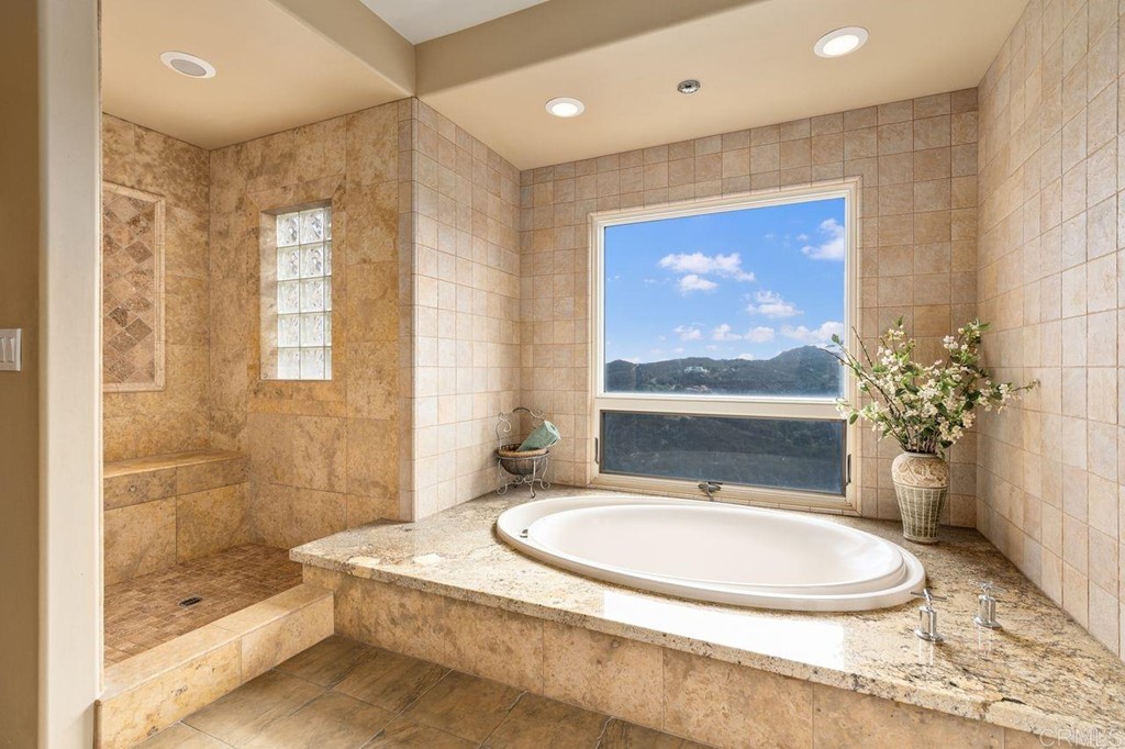 10363 Hidden Meadows Road Escondido, CA 92026 - Photo 60 of 65 a bathroom with a granite countertop sink a toilet a mirror and shower