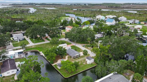 an aerial view of residential houses with outdoor space and river