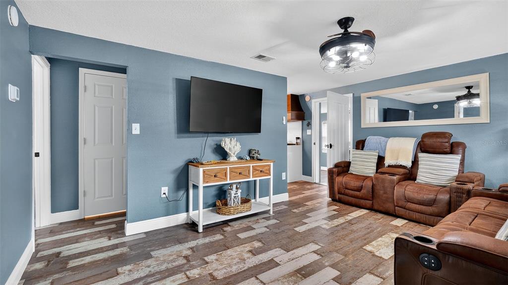 5411 Teal Drive Weeki Wachee, FL 34607 - Photo 12 of 44 a living room with furniture and a flat screen tv