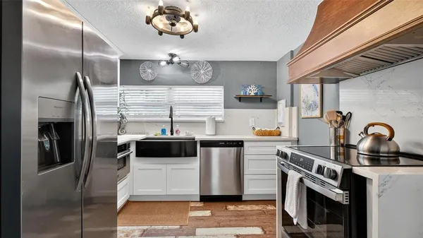 a kitchen with a stove and a refrigerator