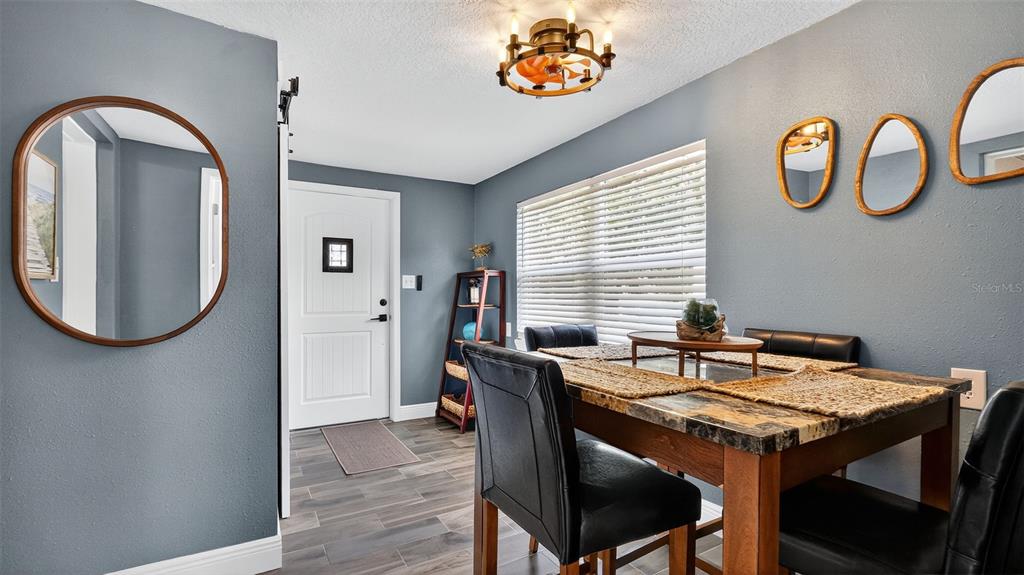 5411 Teal Drive Weeki Wachee, FL 34607 - Photo 18 of 44 a dining room with furniture and window