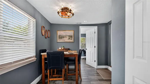 a view of a dining room with furniture and chandelier