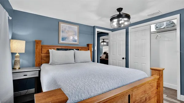 a bedroom with a large bed and a chandelier