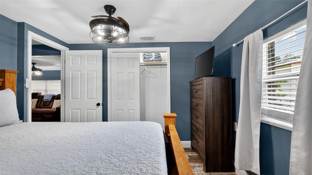 5411 Teal Drive Weeki Wachee, FL 34607 - Photo 22 of 44 a bedroom with a bed and a chandelier