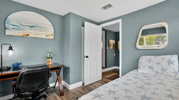 a bedroom with a bed and a chair