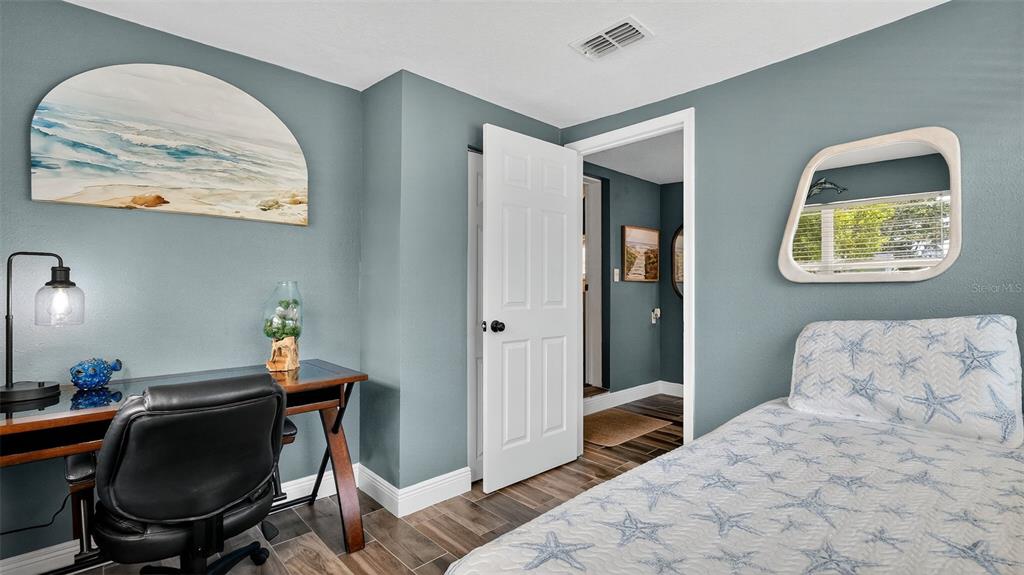 5411 Teal Drive Weeki Wachee, FL 34607 - Photo 27 of 44 a bedroom with a bed and a chair