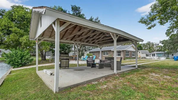 a view of a patio with table and chairs and potted plants