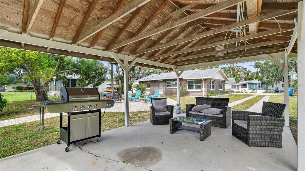 5411 Teal Drive Weeki Wachee, FL 34607 - Photo 38 of 44 a view of a patio with table and chairs and potted plants