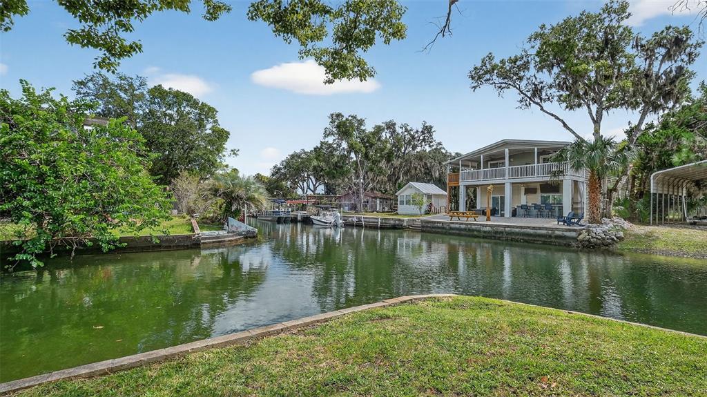 5411 Teal Drive Weeki Wachee, FL 34607 - Photo 39 of 44 a view of a lake with a building in the background