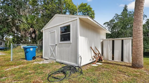 a view of a house with a yard and sitting area