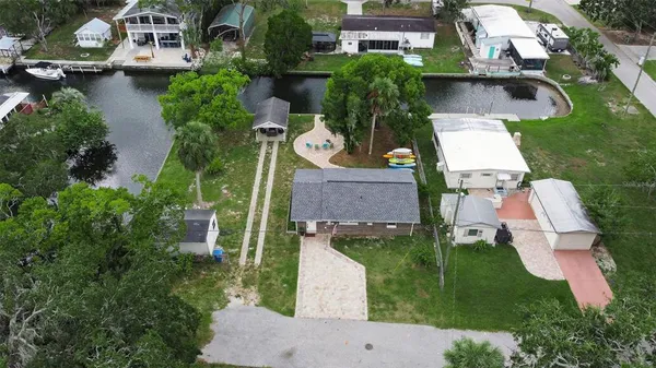 an aerial view of house with yard swimming pool and outdoor seating