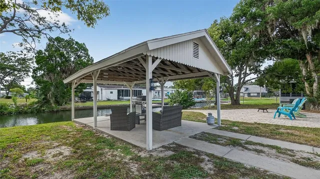 a backyard of a house with table and chairs
