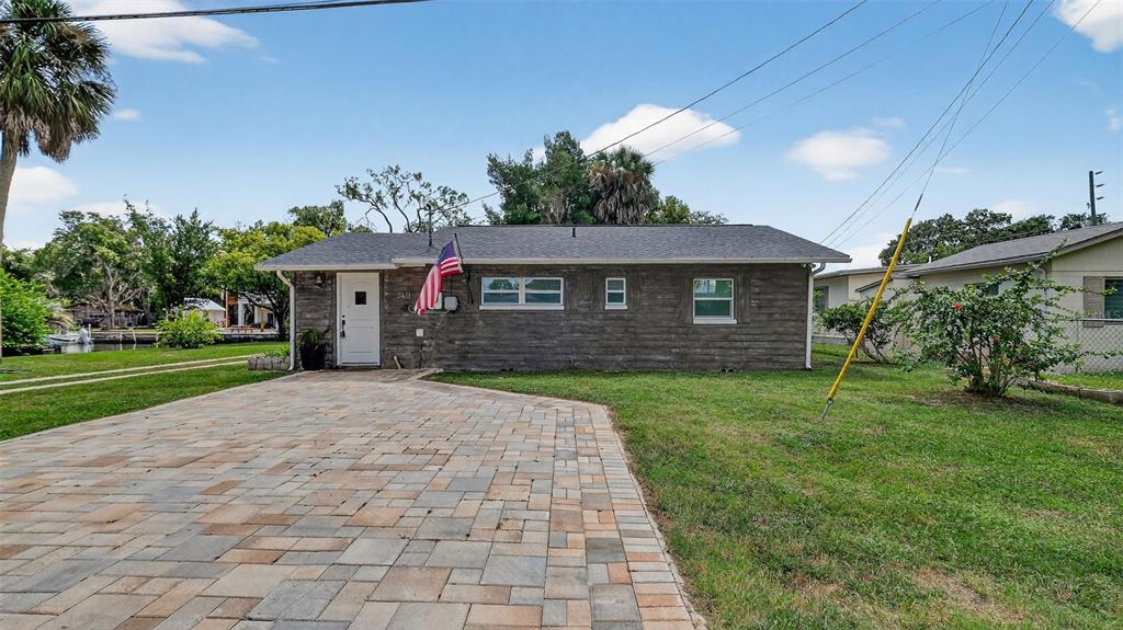 5411 Teal Drive Weeki Wachee, FL 34607 - Photo 9 of 44 a front view of a house with a yard