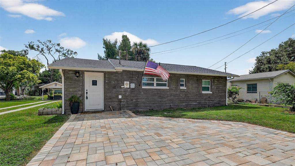 5411 Teal Drive Weeki Wachee, FL 34607 - Photo 10 of 44 a front view of a house with a yard