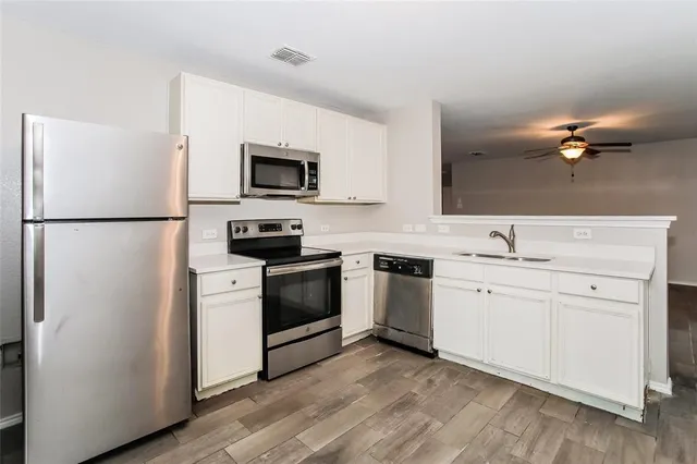 a kitchen with a refrigerator stove and sink