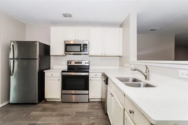a kitchen with a refrigerator sink and microwave