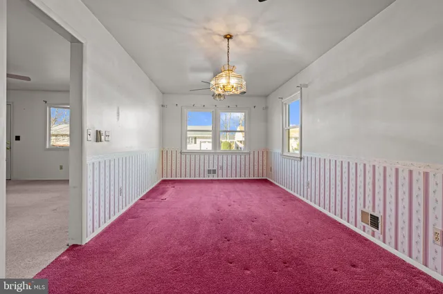 a view of a dining room with furniture and window