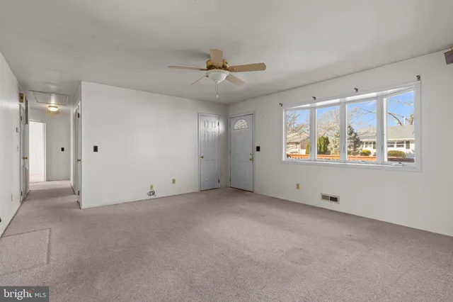 a view of an empty room with a window