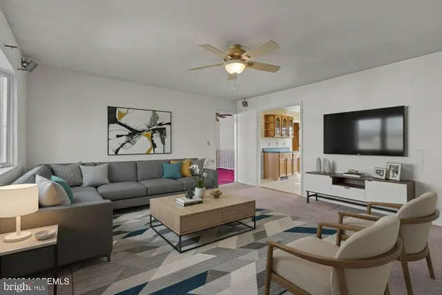 a living room with furniture and a flat screen tv