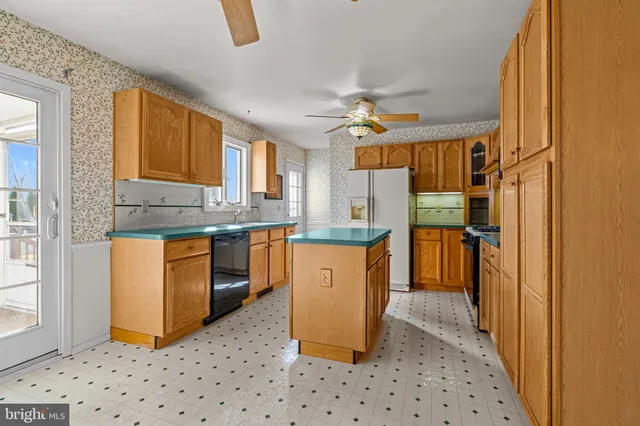 a kitchen with stainless steel appliances granite countertop a refrigerator a sink and dishwasher