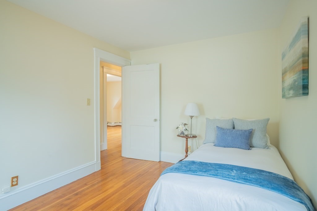 47 Pilgrim Road Marblehead, MA 01945 - Photo 20 of 42 a bedroom with a bed and wooden floor