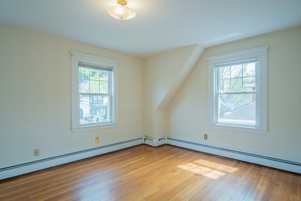47 Pilgrim Road Marblehead, MA 01945 - Photo 21 of 42 an empty room with wooden floor and windows