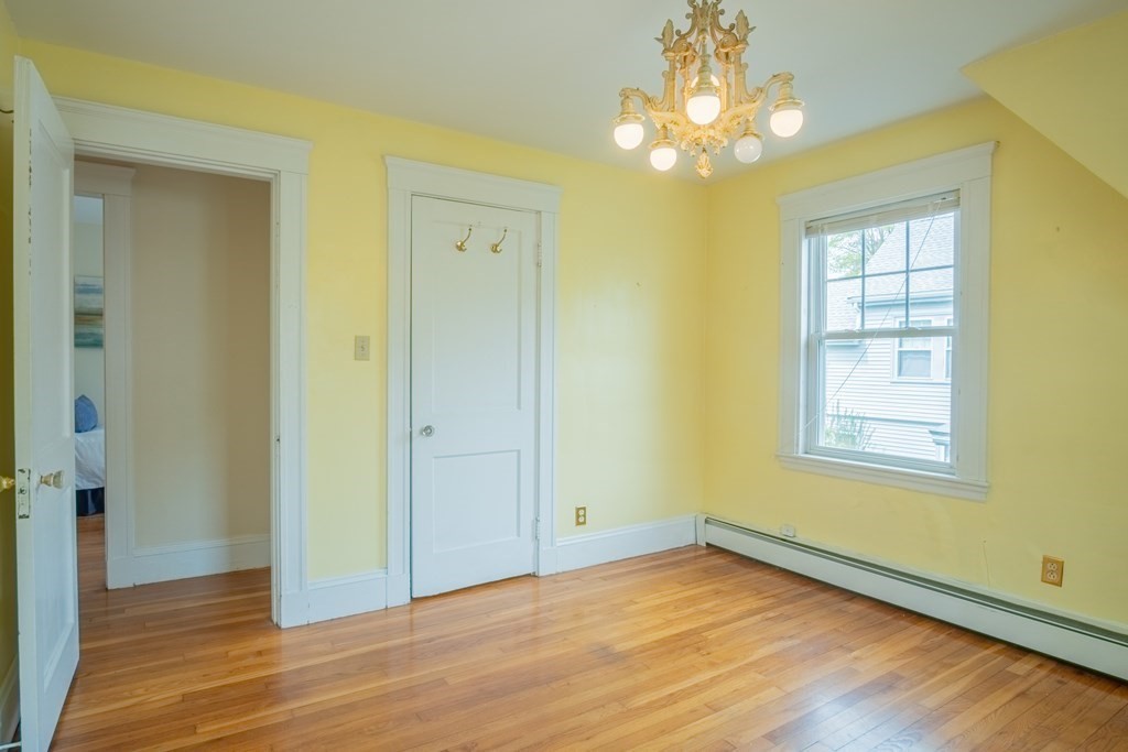 47 Pilgrim Road Marblehead, MA 01945 - Photo 24 of 42 a view of an empty room with wooden floor and a window